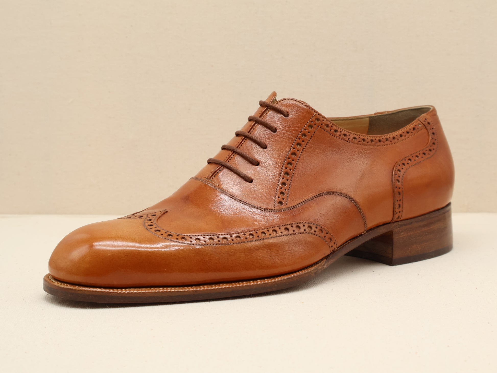 Bespoke Semi-Brogue Oxford, handcrafted from fine vegetable-tanned box calf leather in a warm tan patina. Featuring elegant punched detailing, a refined French toe shape, and a Goodyear-welted leather sole by euGo, The Art of Shoemaking, Burlingame, California.