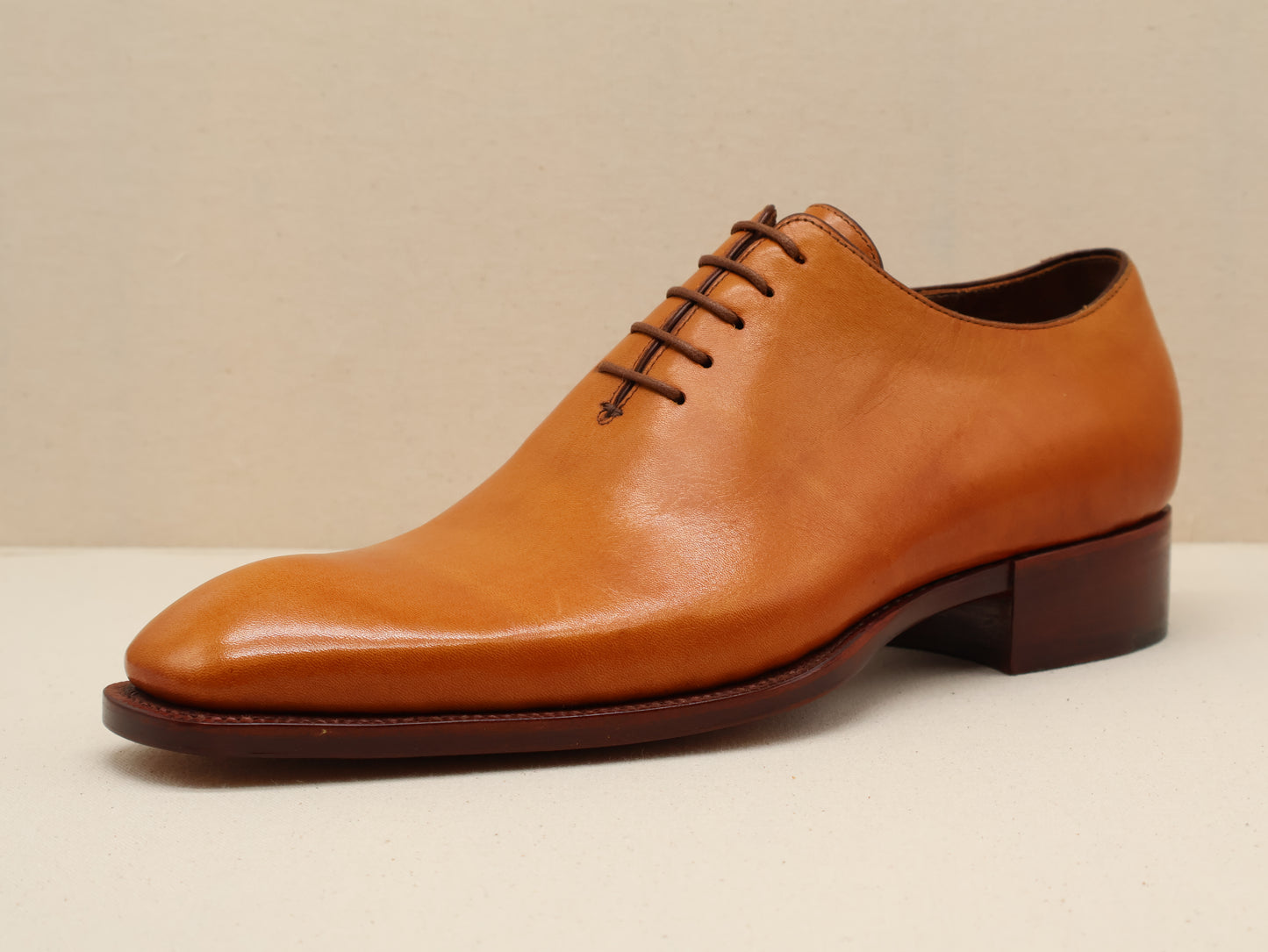 Bespoke Wholecut Oxford, sculpted from a single piece of fine French box calf leather in a rich cognac patina. Designed with a sleek French toe shape and finished with a Goodyear-welted leather sole by euGo, The Art of Shoemaking, Burlingame, California.
