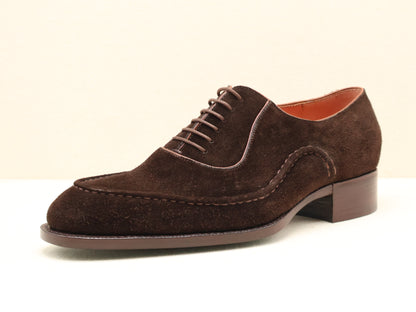 Bespoke Wholecut Oxford in Chocolate Suede, featuring a unique hand-stitched apron-style toe that adds subtle character to its seamless design. Handcrafted from fine English suede and finished with a Goodyear-welted leather sole by euGo, The Art of Shoemaking, Burlingame, California.